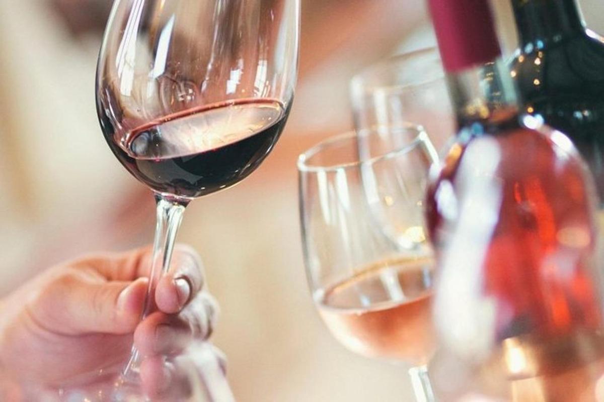 a person is holding a glass of wine