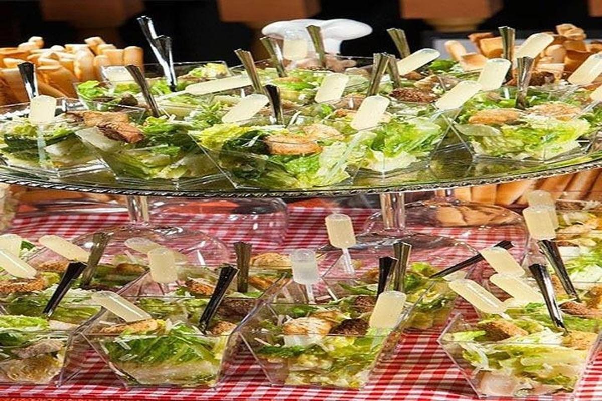 a buffet of sandwiches and salads in plastic containers