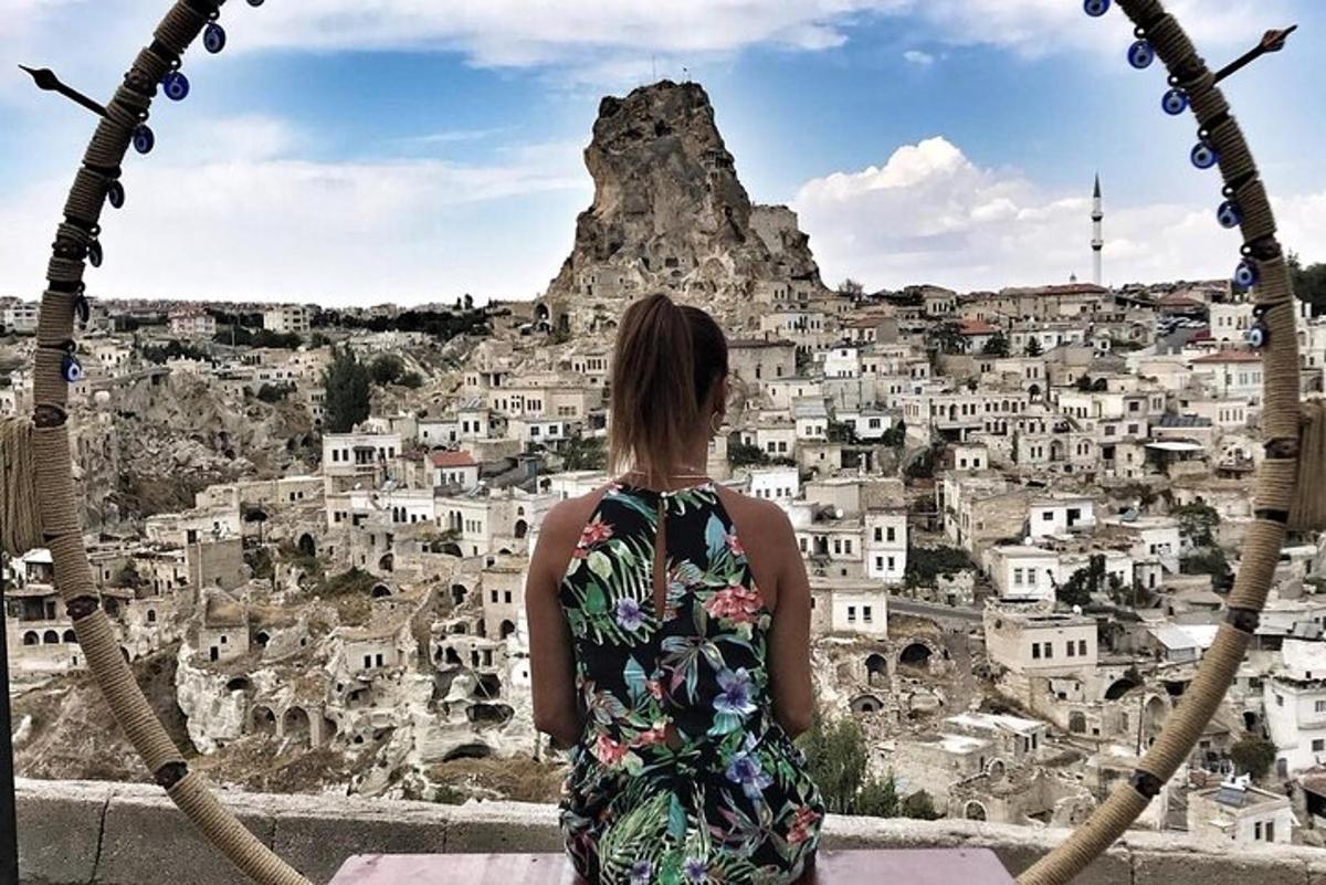 a woman in a dress looking at a mountain