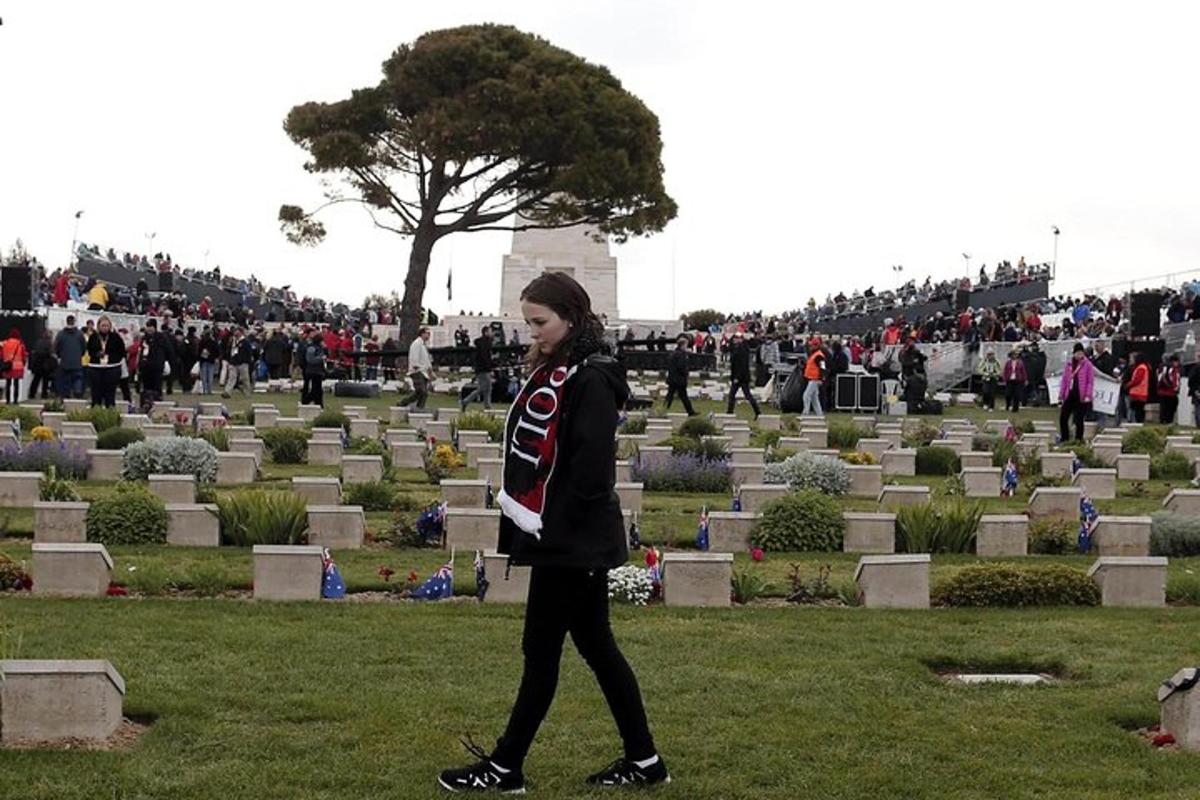 una dona caminant davant d'un cementiri