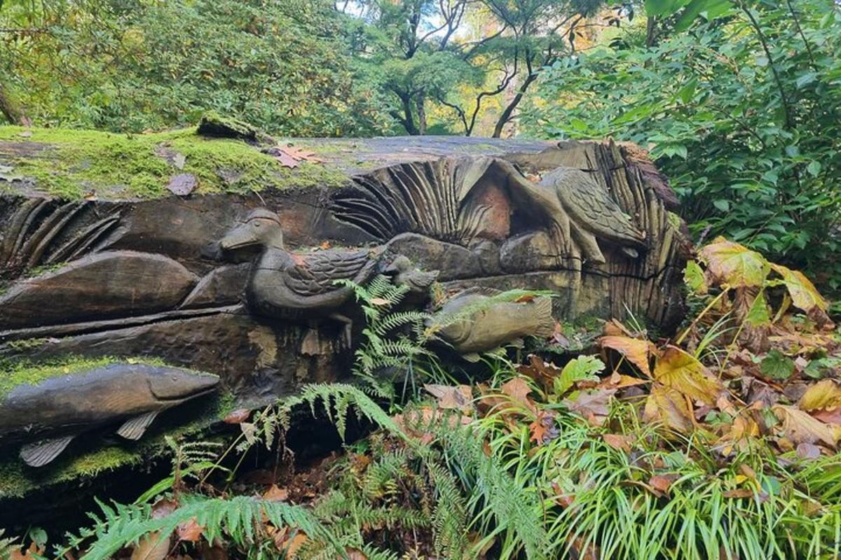 a statue of a bird sitting on a rock