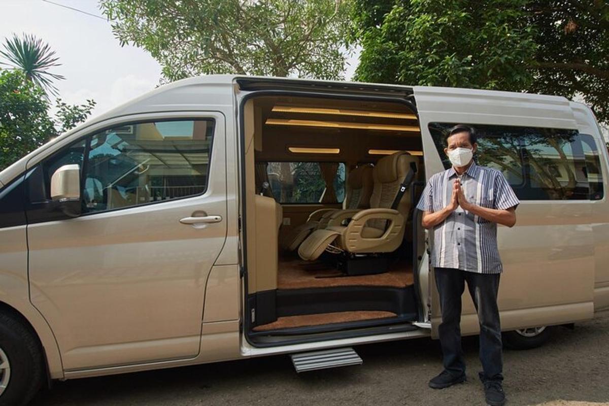 a man wearing a mask standing in front of a van