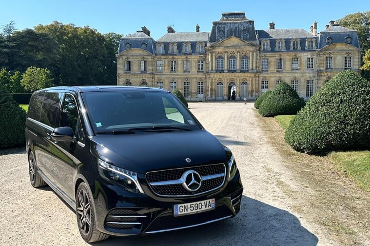 a black car parked in front of a large building