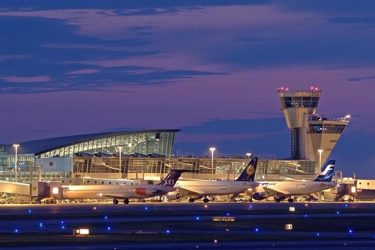 a group of airplanes parked at an airport at night