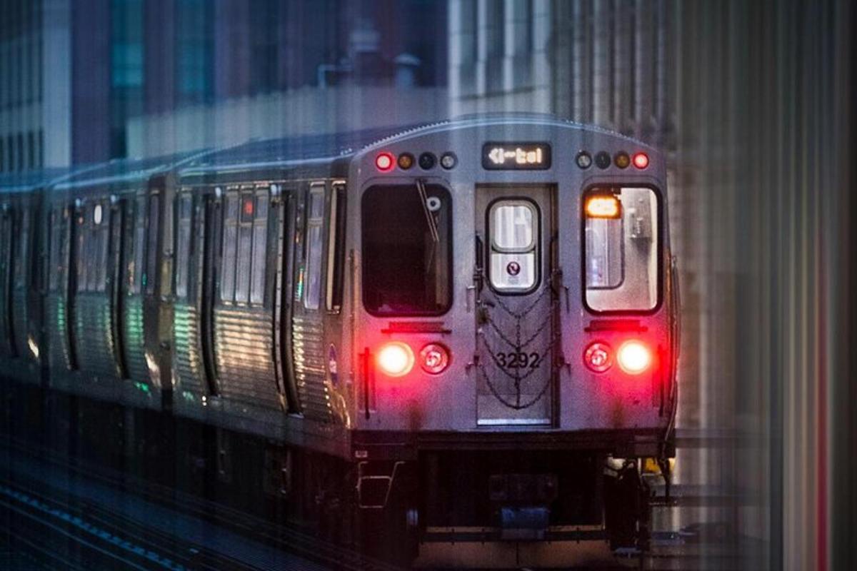 a train traveling down the tracks with its lights on