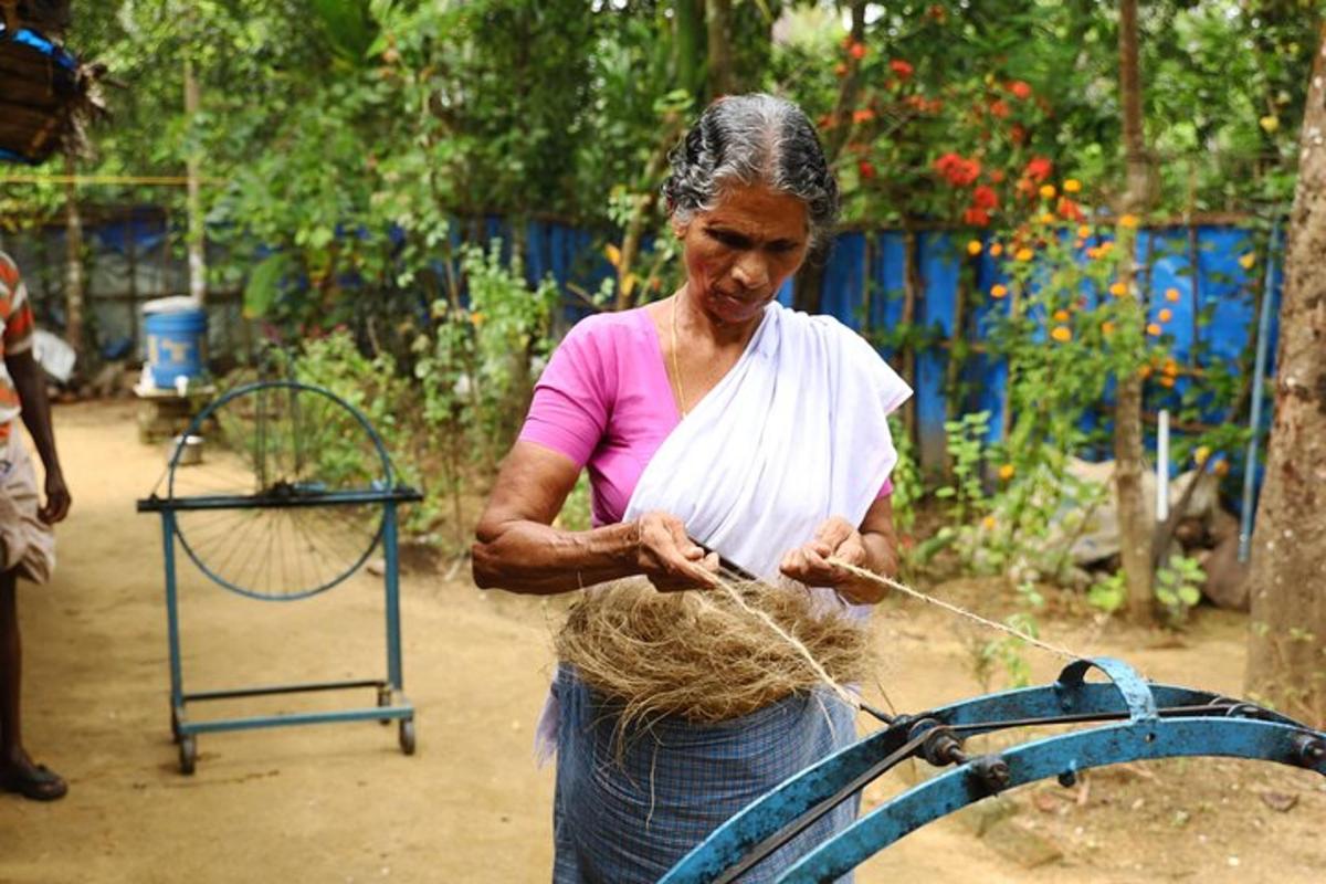 a woman is cutting hair with a rope