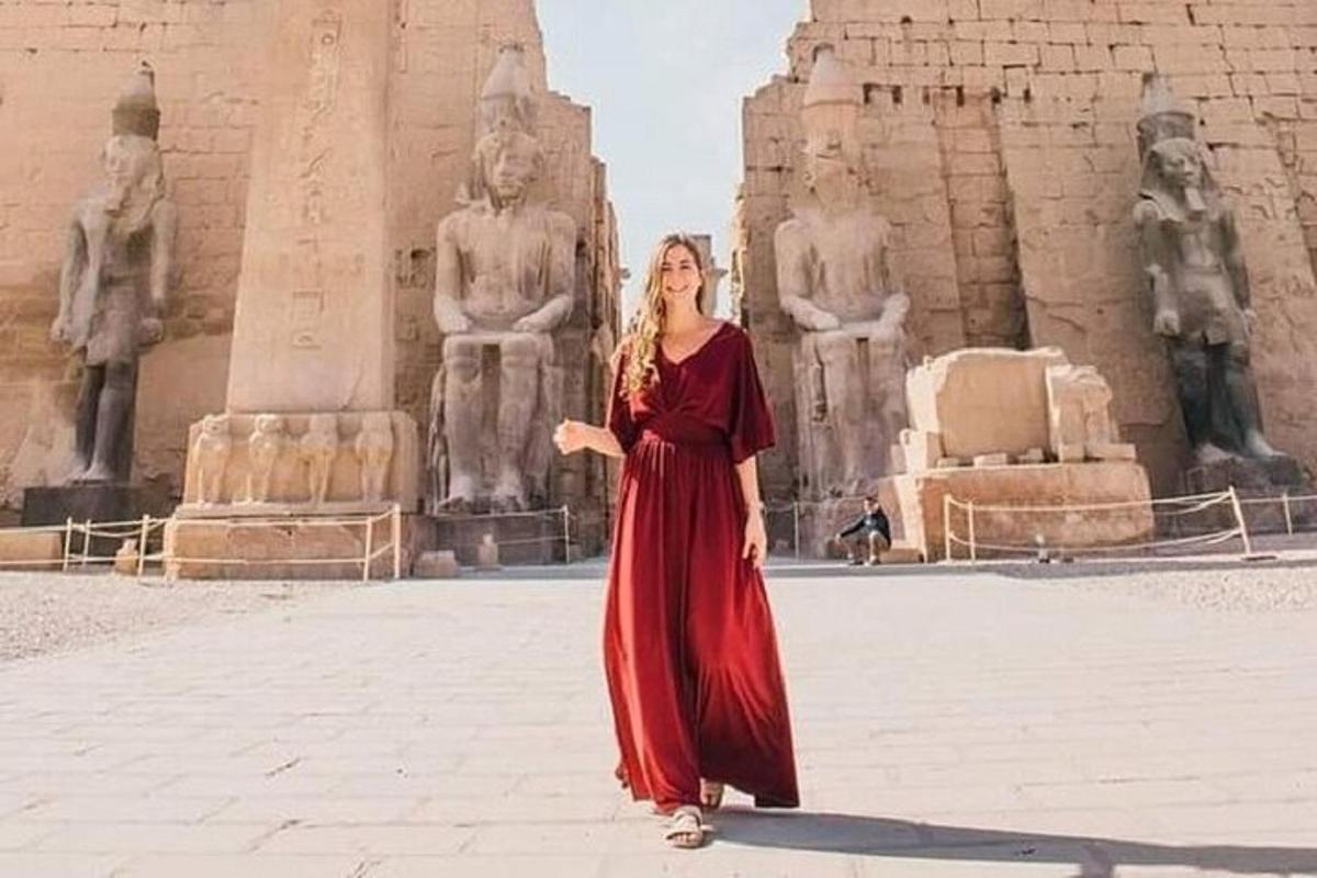 una donna in un vestito rosso in piedi davanti a un edificio
