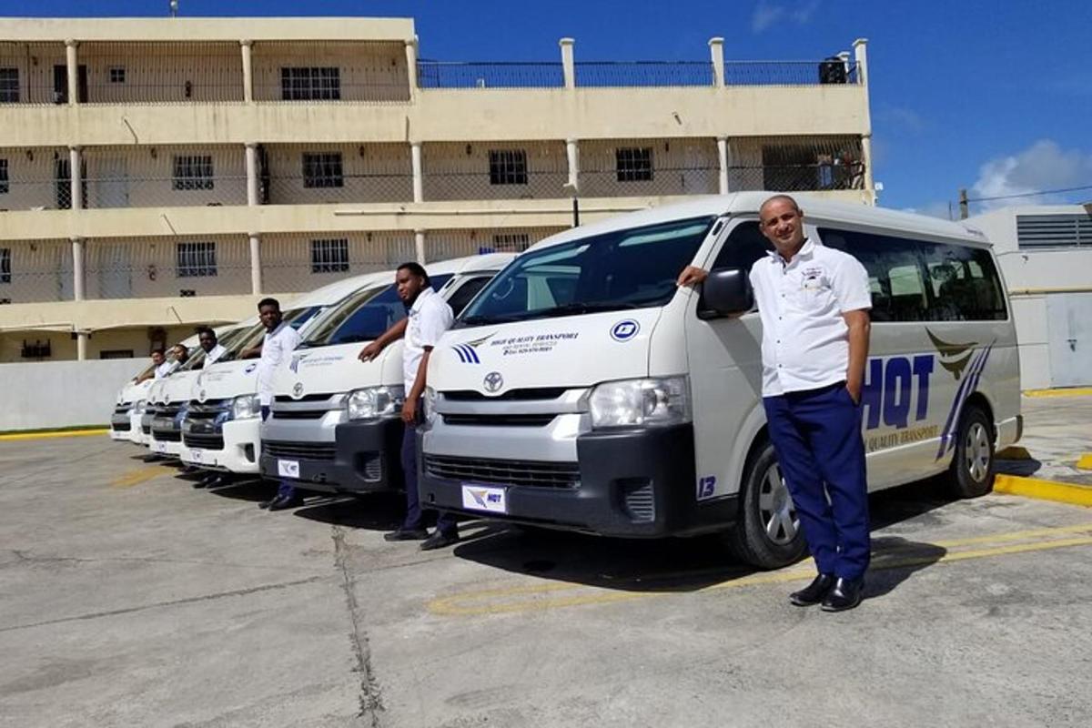 a group of men standing next to a row of vans