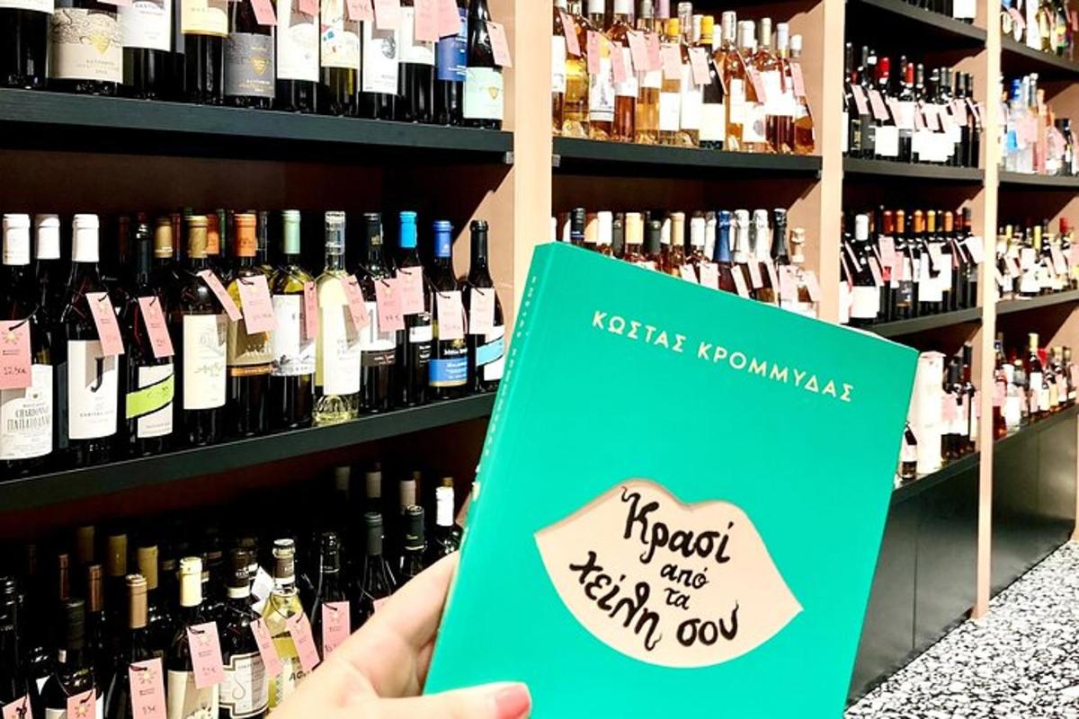inimene, kes hoiab veinipudelite ees raamatut