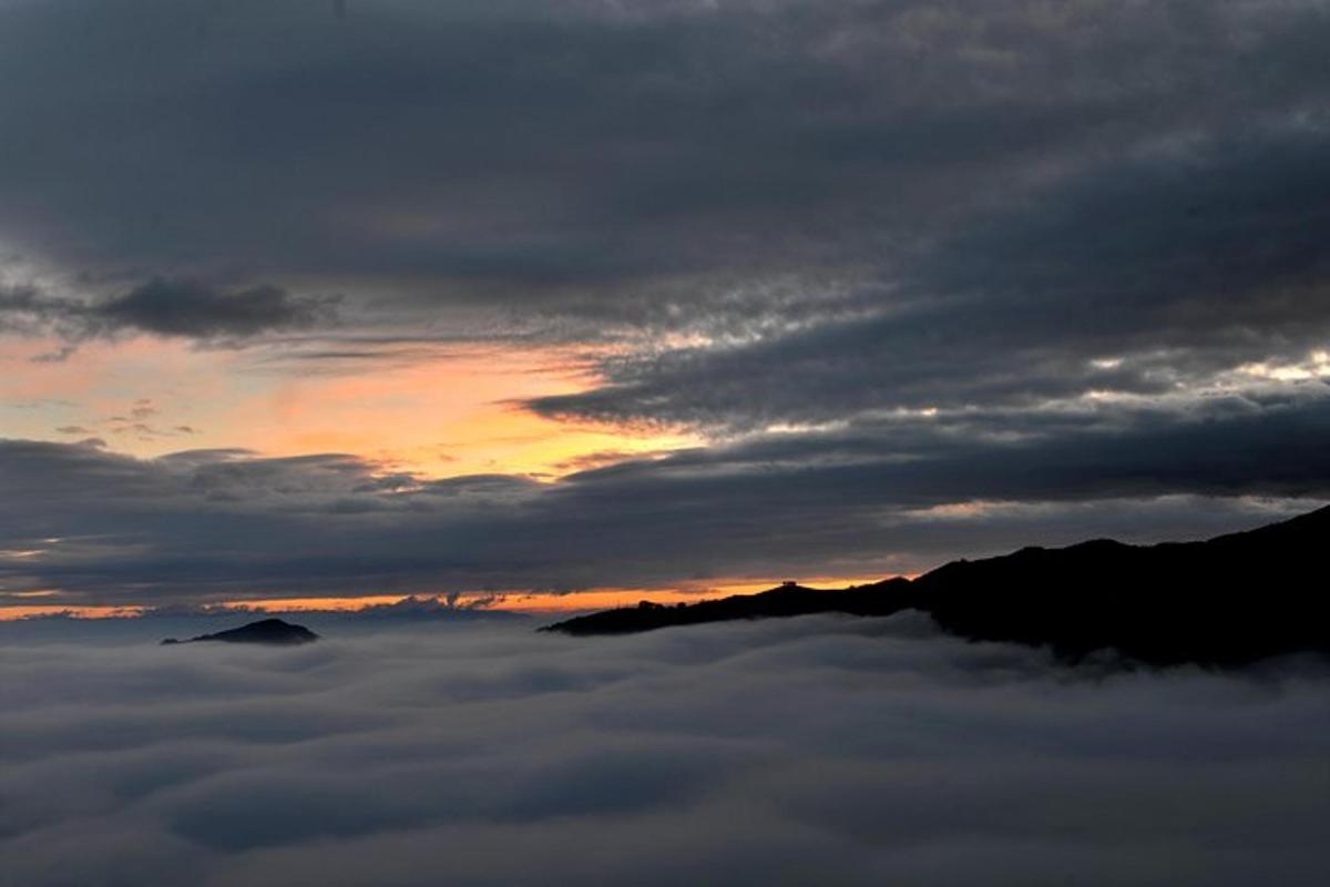 a view of the sunset from above the clouds