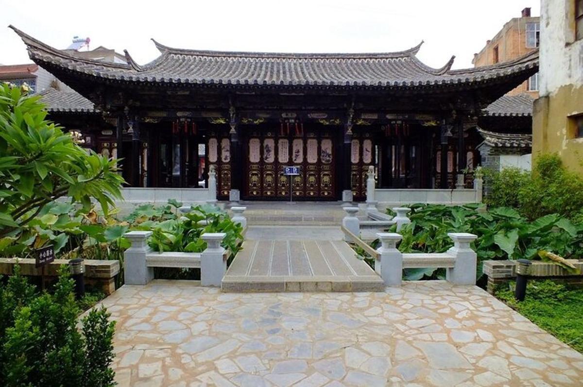 a pavilion with benches in front of a building