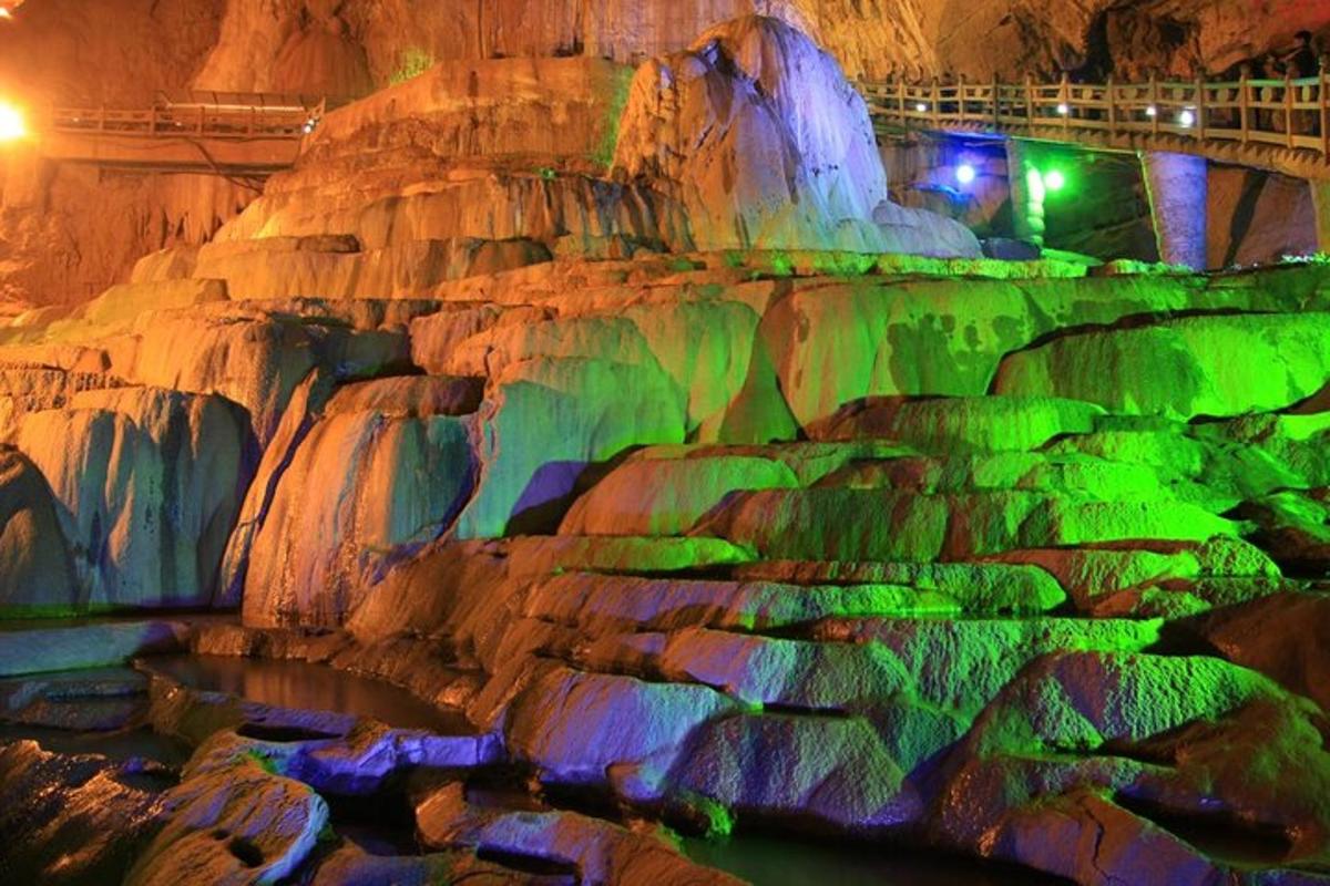 a rock cave with green and purple lights