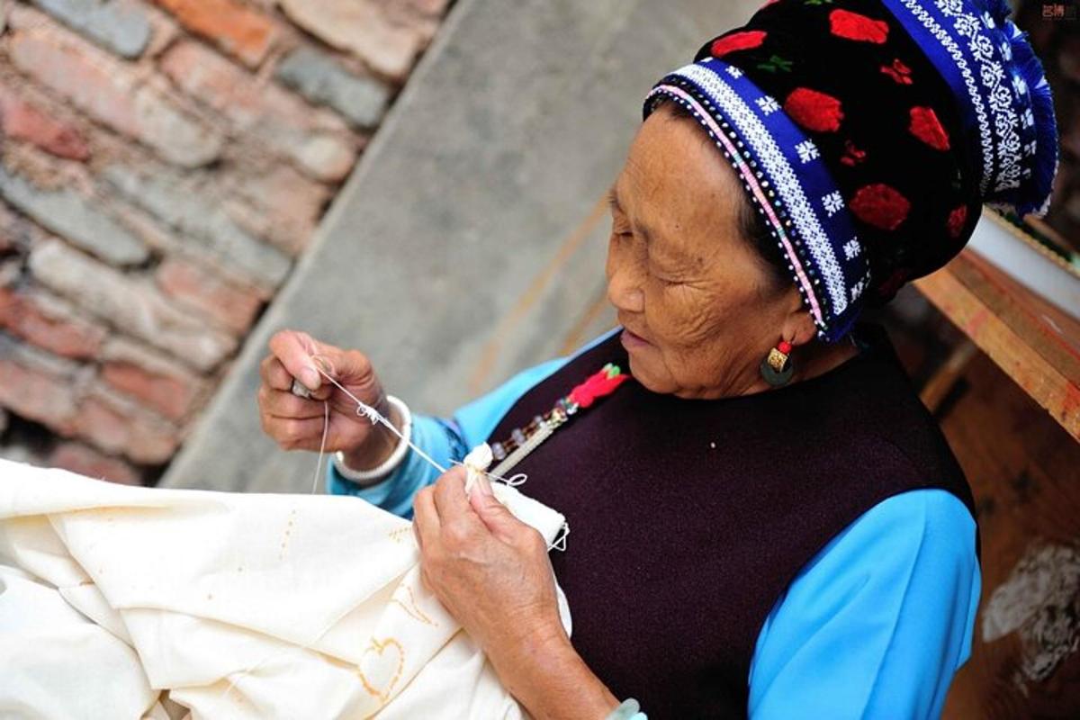 an older woman wearing a headdress holding a string