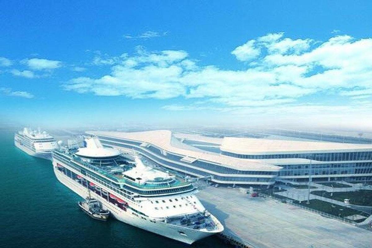 two cruise ships are docked at a harbor
