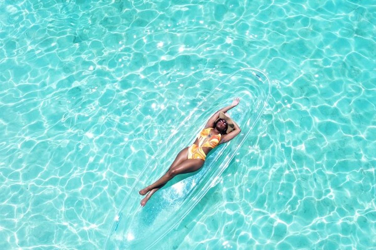 a woman laying on a surfboard in the water