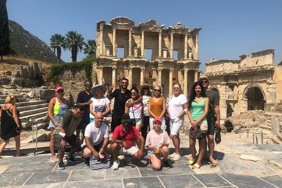 a group of people posing in front of the ruins