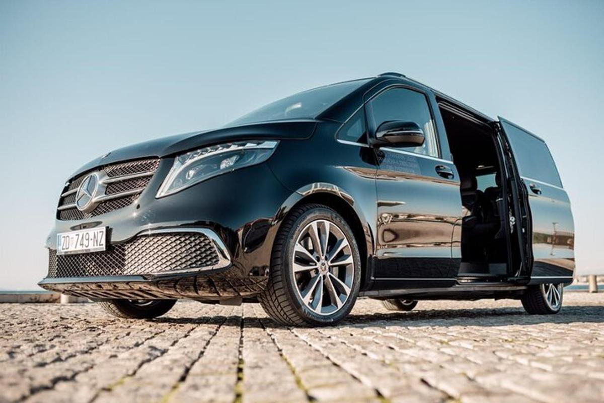 a black van parked on a brick road