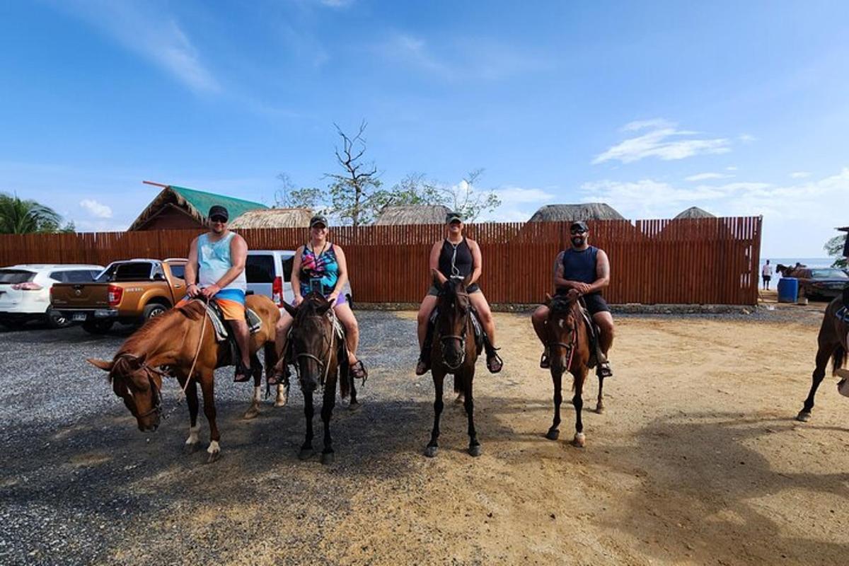a group of people riding horses in a field