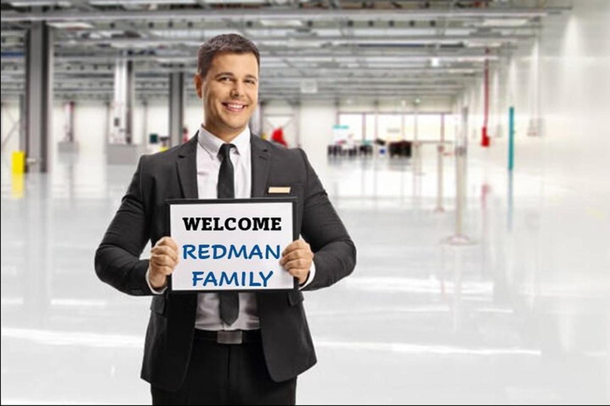 a man is holding a sign that reads welcome reagan family