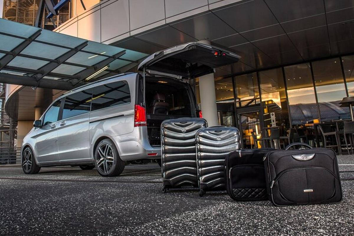 a pile of luggage sitting next to a van