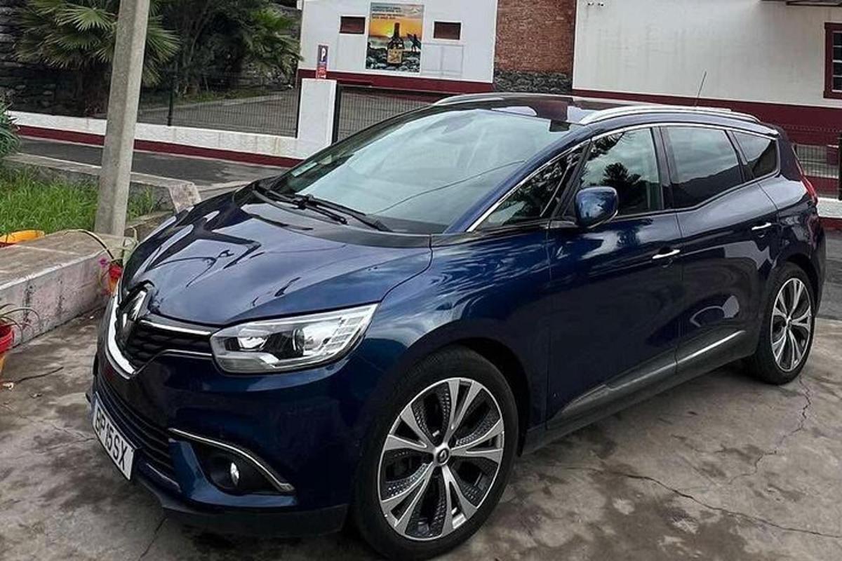 a blue car parked in a parking lot