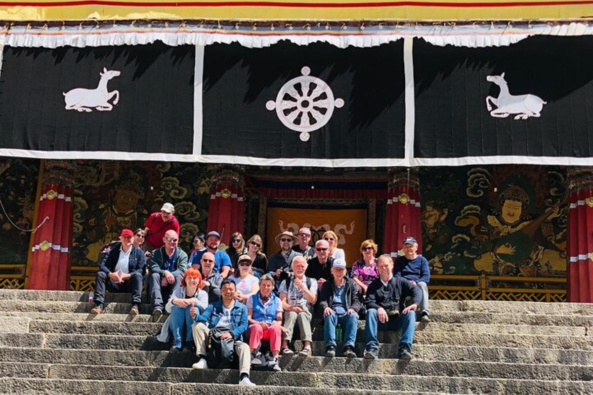 a group of people sitting on steps in front of a building