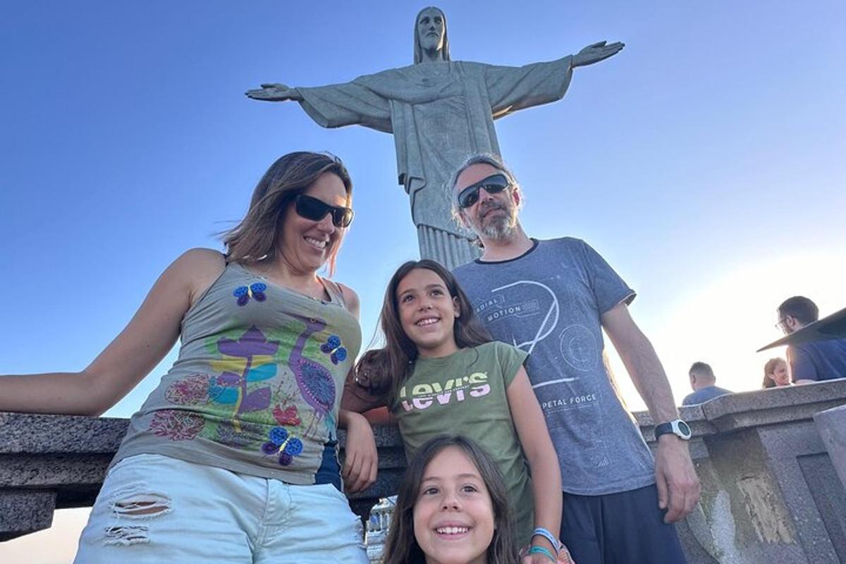 un gruppo di persone in piedi davanti alla statua del Cristo Redentore