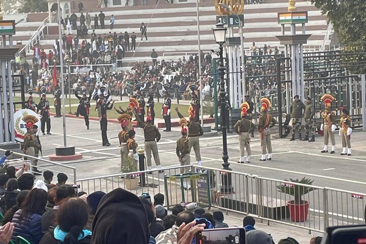 a crowd of people watching a marching band in a parade