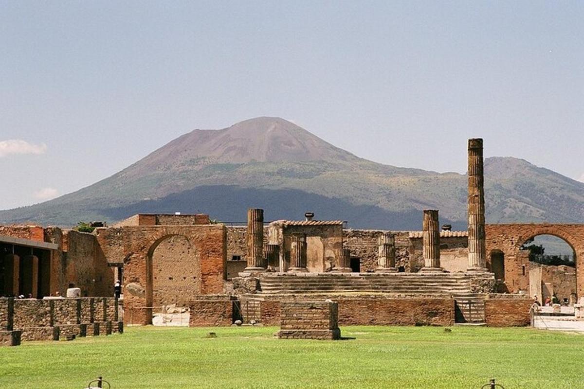 an ancient building with a mountain in the background
