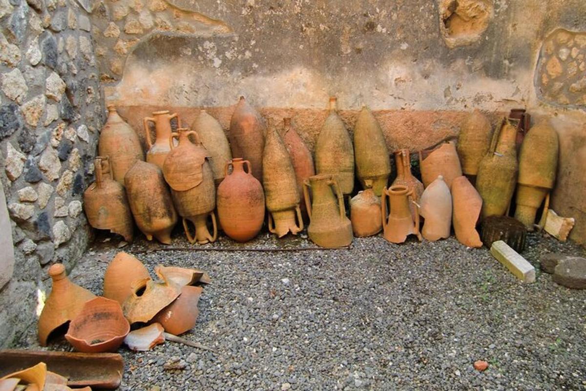 a group of vases lined up against a wall