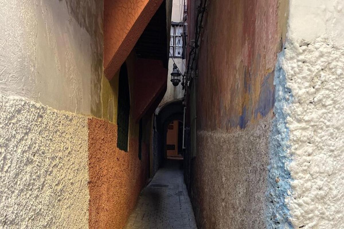 a narrow alley with a door in a building