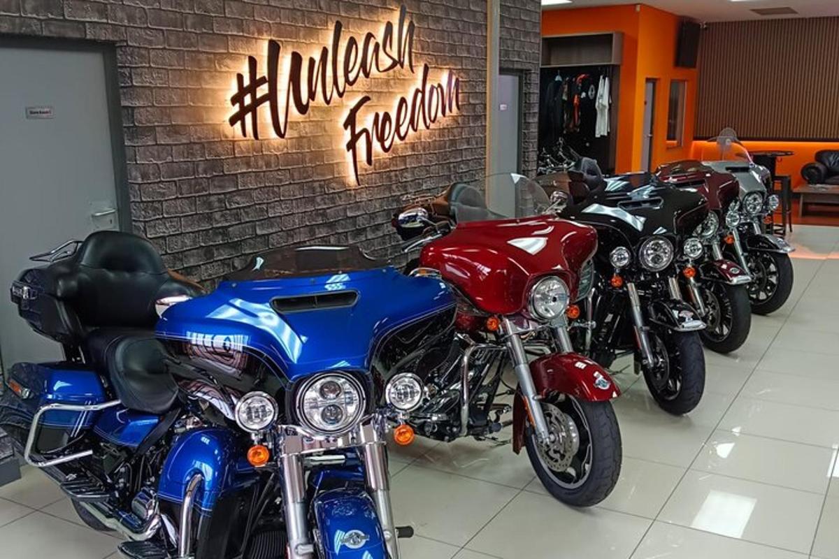 a row of motorcycles parked next to a brick wall