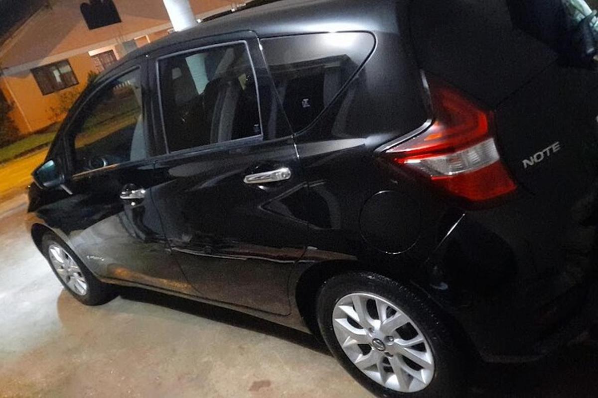 a small black car parked in a garage