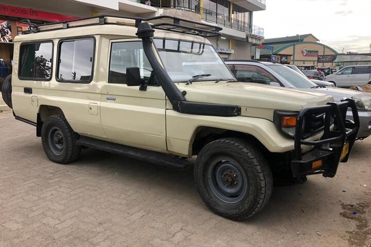 a white jeep parked in a parking lot