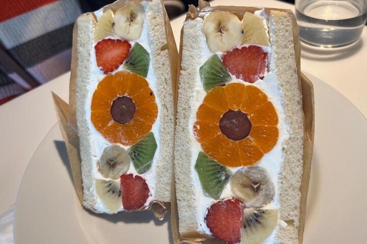 two sandwiches with fruit on them on a table