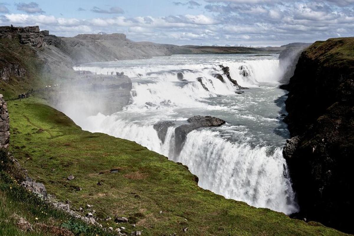 a waterfall on the side of a river