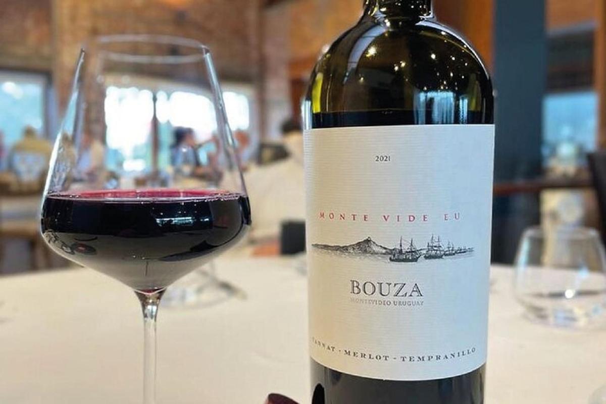 a bottle of wine sitting next to a glass of wine
