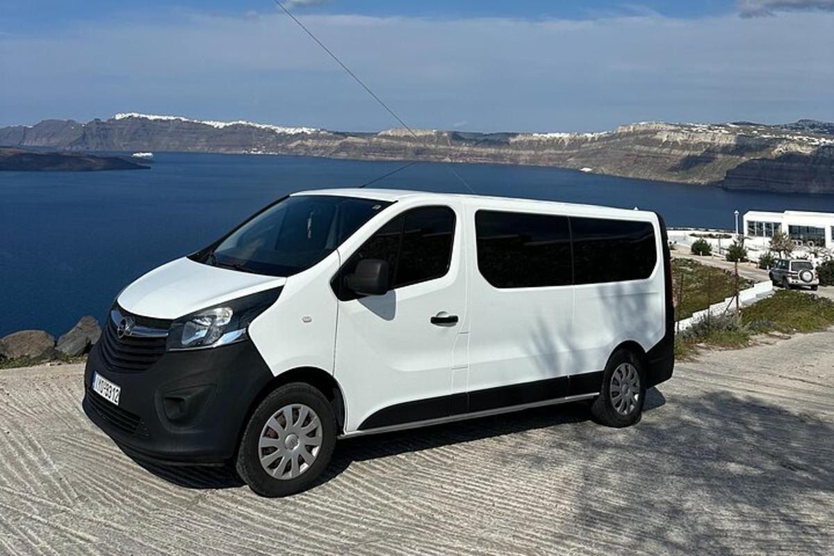 uma van branca estacionada ao lado de um corpo d'água