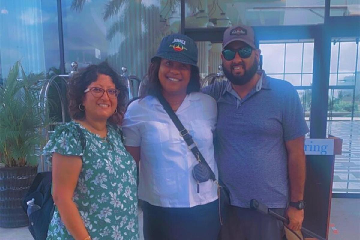 a group of three people posing for a picture