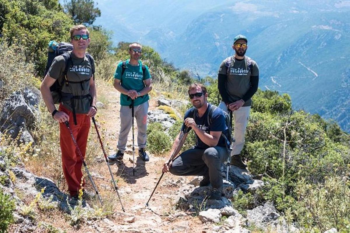 a group of people standing on top of a mountain