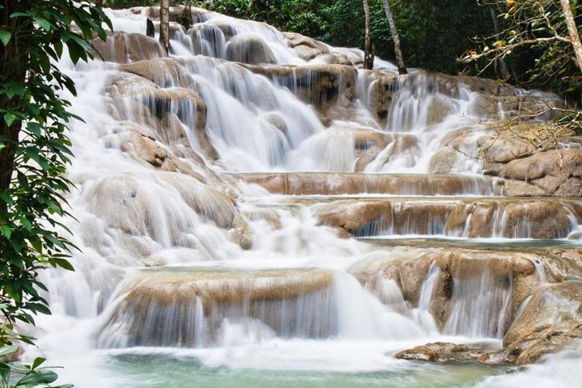 a series of waterfalls with rocks and trees