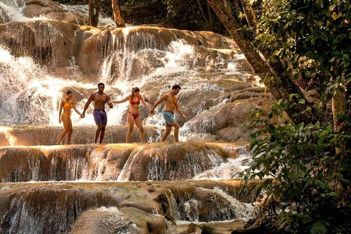 a group of people standing on rocks in a waterfall