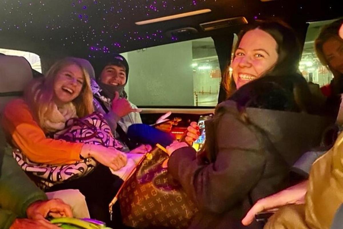 a group of people sitting in the back of a van