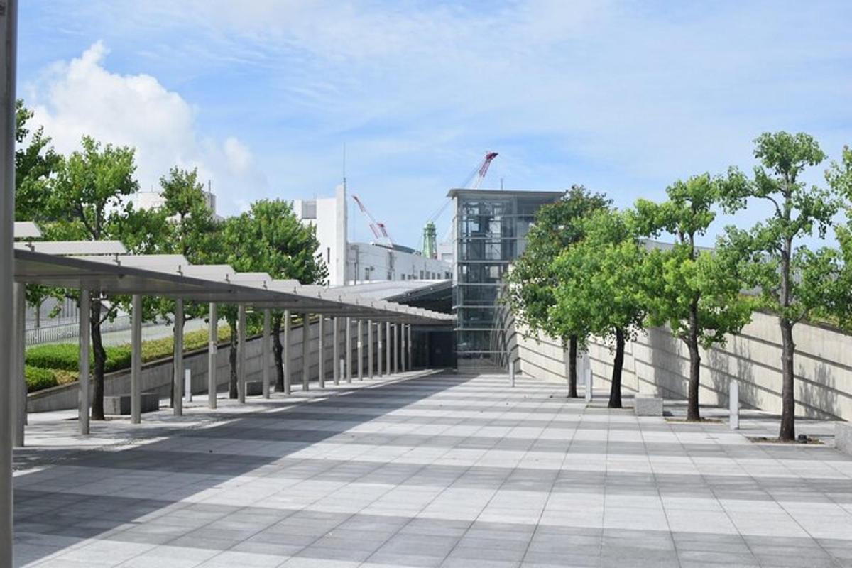 a walkway with trees on the side of a building