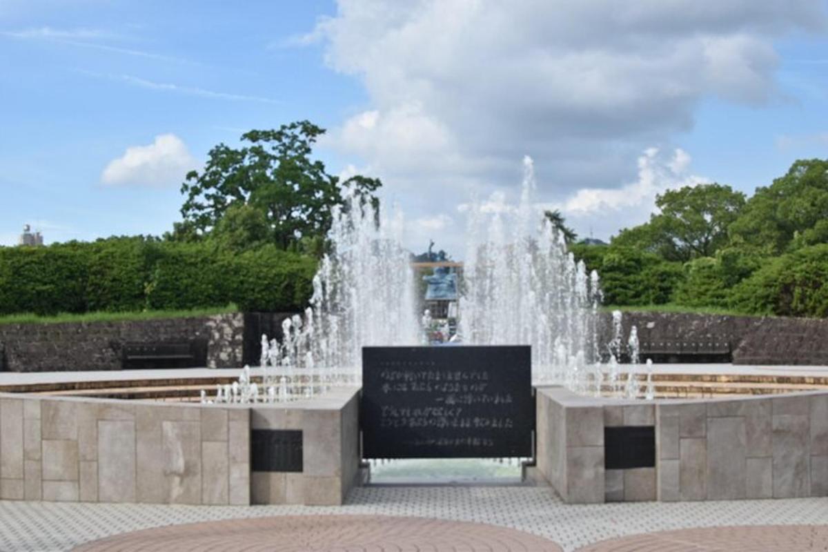 a fountain with a sign in front of it