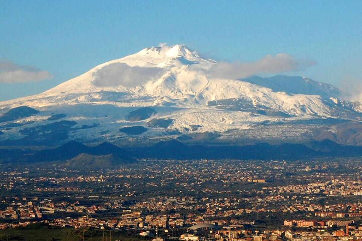 une montagne enneigée devant une ville