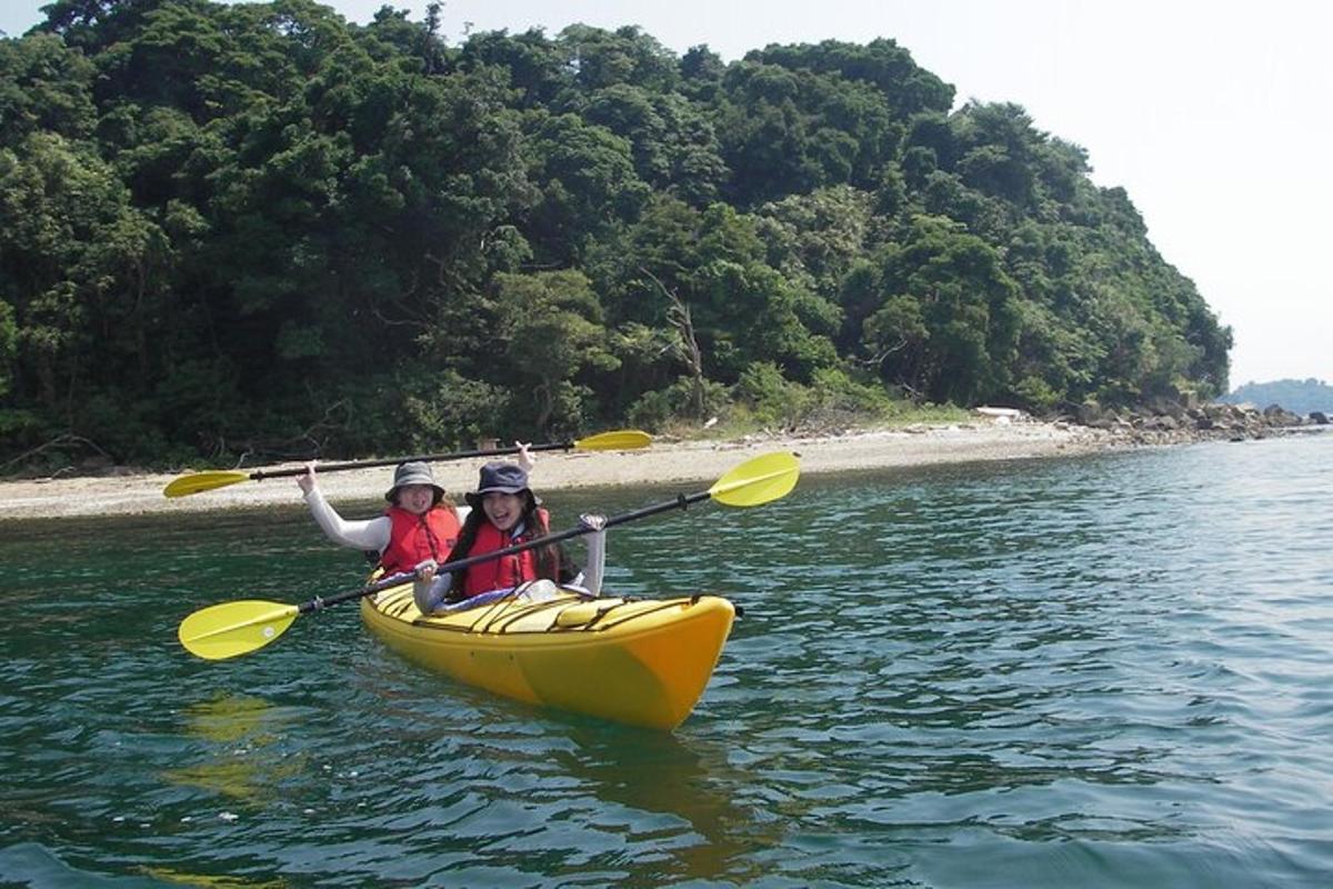 two children are in a yellow kayak in the water