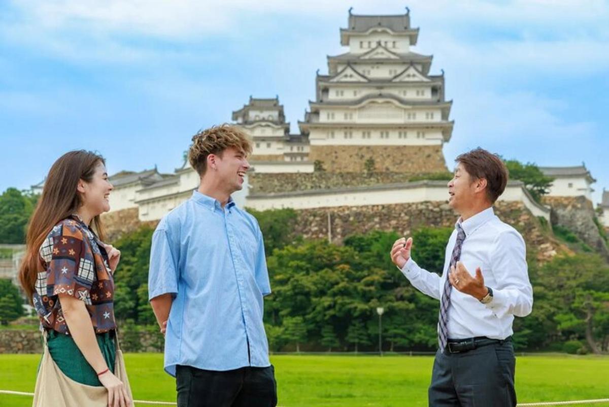 a group of three people standing in front of a castle