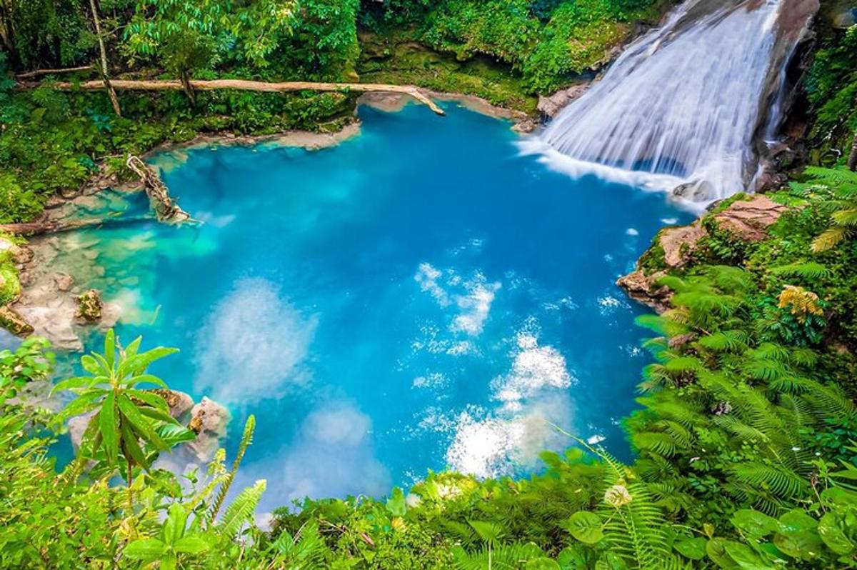 a waterfall and a blue pool of water in a river