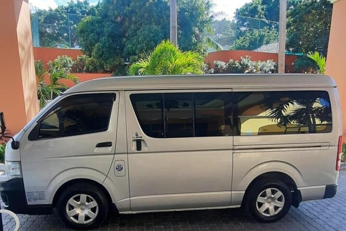 uma van branca estacionada em frente a um prédio